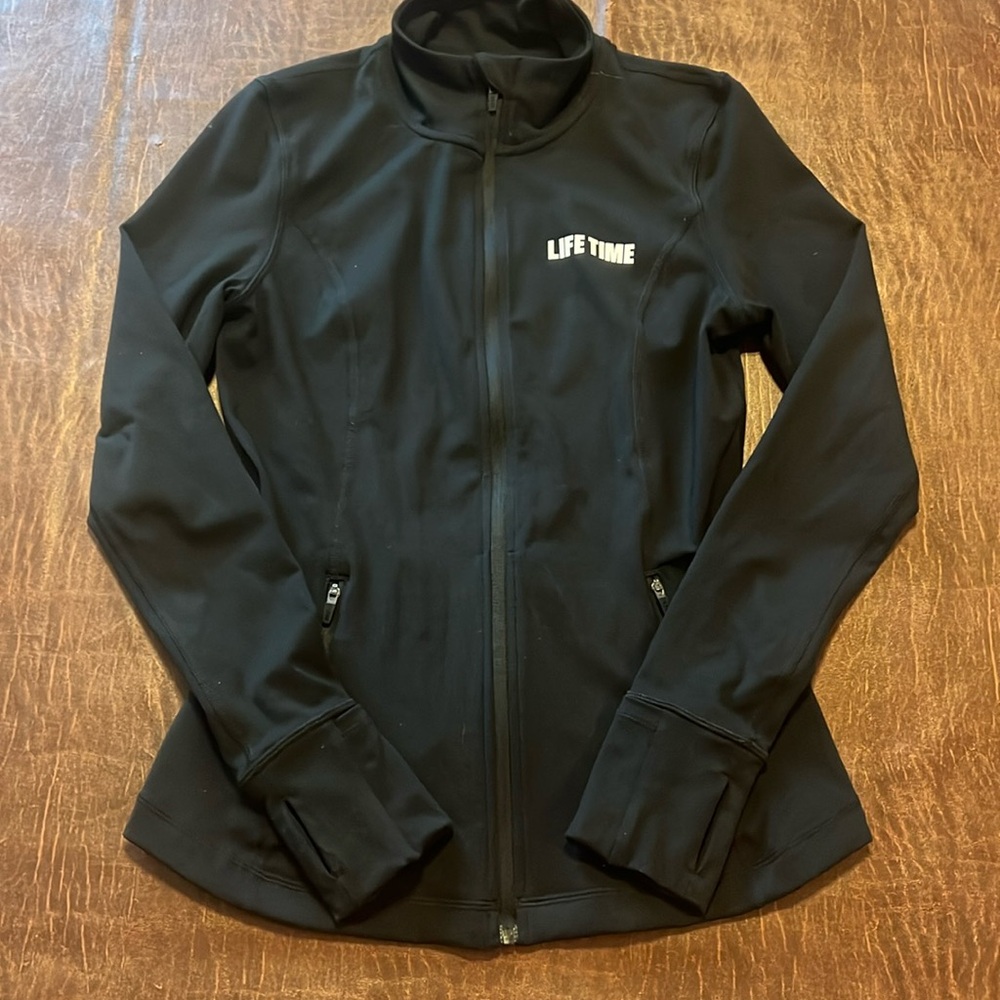 Lifetime Fitness brand, black polyester jacket with thumb holes zipper pockets